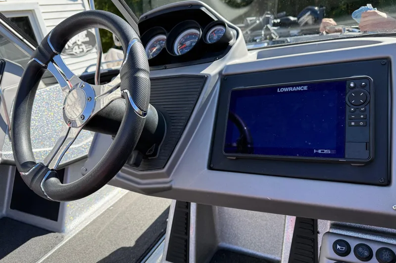 Slide: The Image of 2023 Ranger 1850 Reata boat dashboard with steering wheel and Lowrance HDS display. - 6