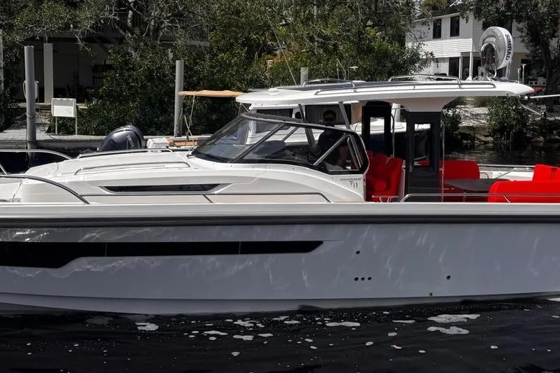 The Image of 2025 Nimbus Tender 11 boat with sleek design and vibrant red seating. - 0