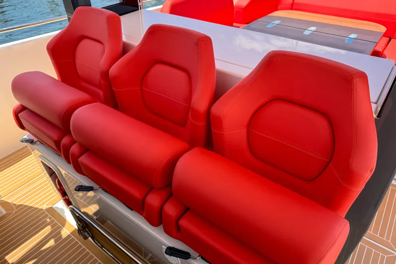Slide: The Image of Red seats on 2025 Nimbus Tender 11 boat, showcasing luxury and comfort. - 12
