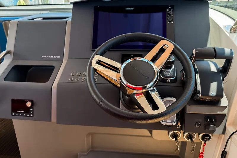 Slide: The Image of Steering console of 2025 Nimbus Tender 11 with modern controls and display. - 14