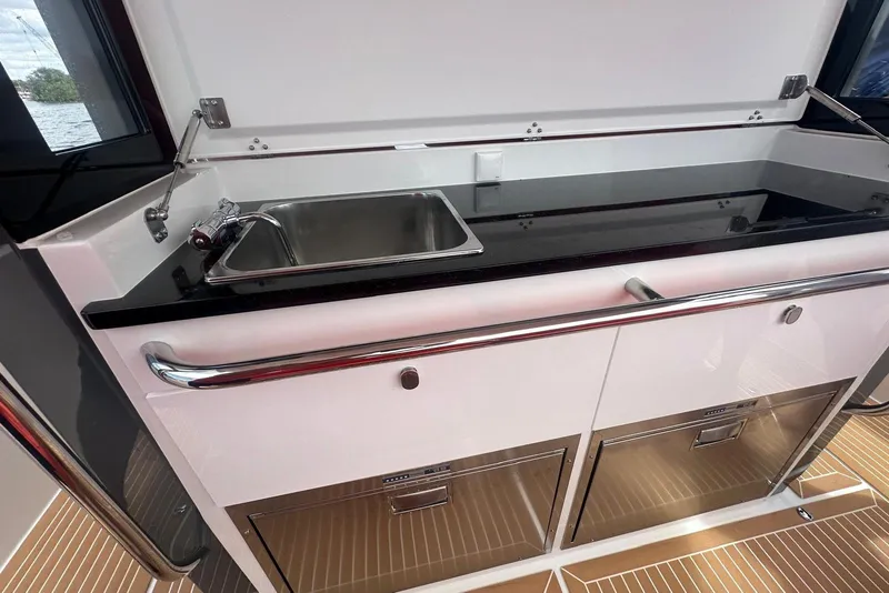 Slide: The Image of Modern kitchen area on 2025 Nimbus Tender 11 boat with sink and storage. - 8