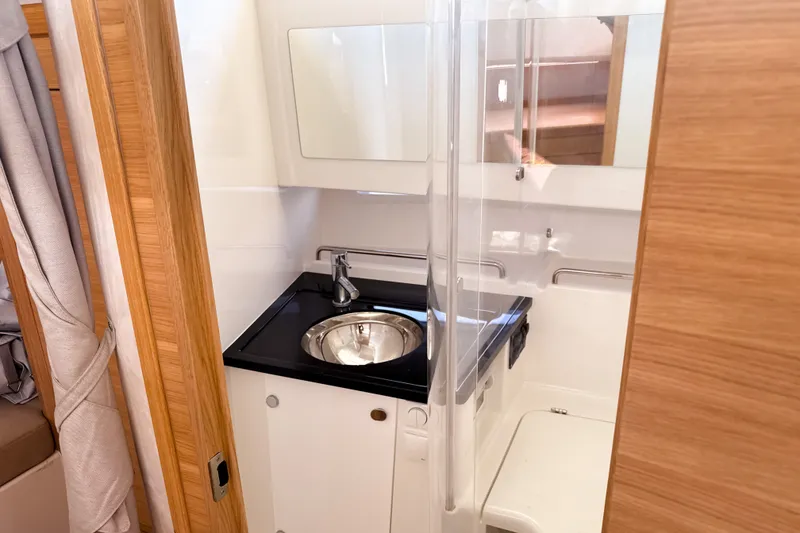 Slide: The Image of Modern bathroom interior of 2025 Nimbus Tender 11 yacht, featuring sleek sink and wooden accents. - 20