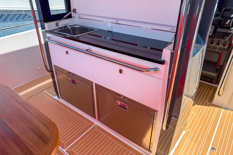 Slide: The Image of Modern kitchen area on 2025 Nimbus Tender 11 yacht with sleek design and stainless steel appliances. - 10