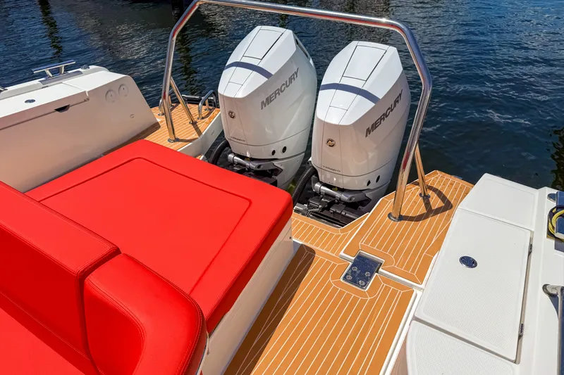 Slide: The Image of 2025 Nimbus Tender 11 boat with dual Mercury engines and vibrant red seating. - 3
