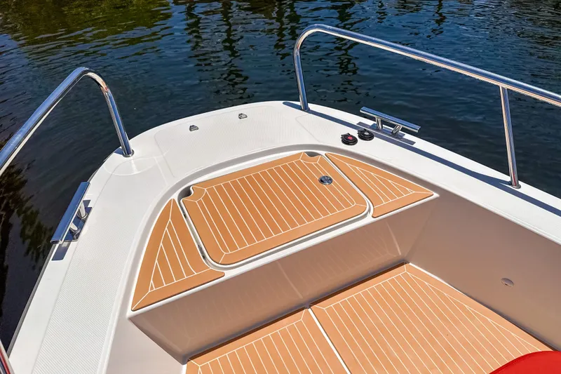 Slide: The Image of 2025 Nimbus Tender 11 boat deck with sleek wood finish and stainless steel railings. - 28