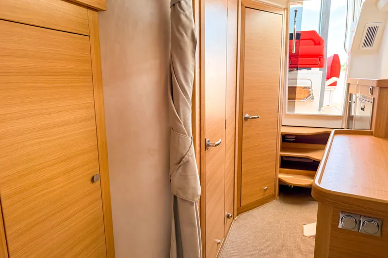 Slide: The Image of Interior of 2025 Nimbus Tender 11, featuring wooden cabinetry and modern design elements. - 16