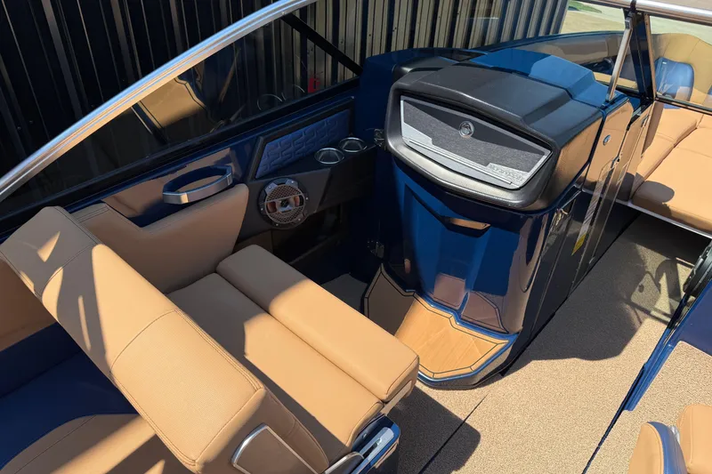 Slide: The Image of 2019 MasterCraft X26 boat interior with tan seating and blue accents. - 3