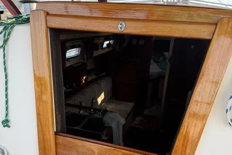 Slide: The Image of 1989 Island Packet 31 sailboat interior view with wooden hatch and cabin details. - 13
