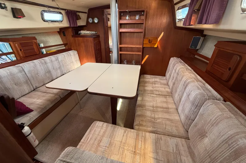 Slide: The Image of Interior of 1989 Island Packet 31 sailboat with cozy seating and dining area. - 18