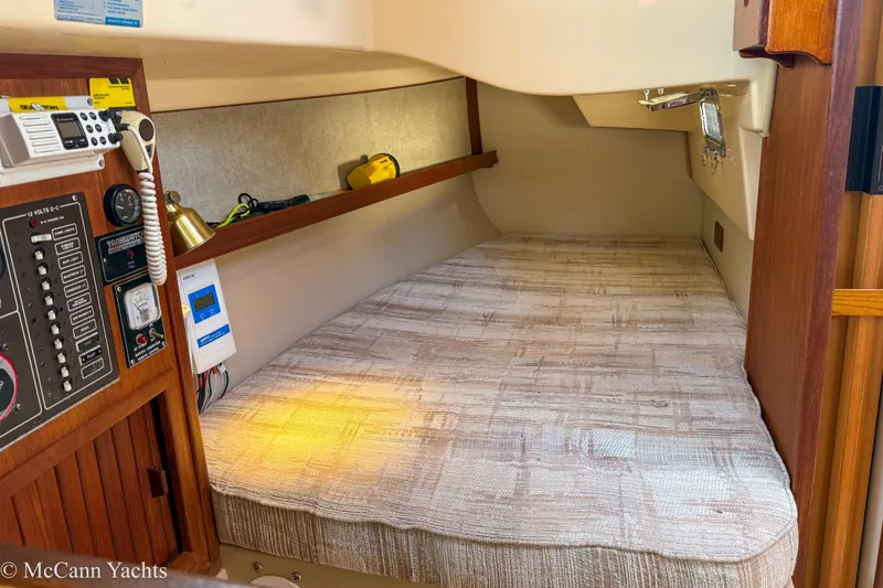 Slide: The Image of Cozy cabin interior of 1989 Island Packet 31 sailboat with navigation equipment. - 25