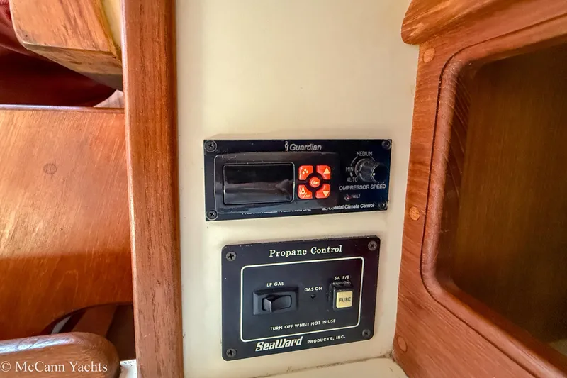 Slide: The Image of Control panel on 1989 Island Packet 31 yacht, featuring climate and propane controls. - 39