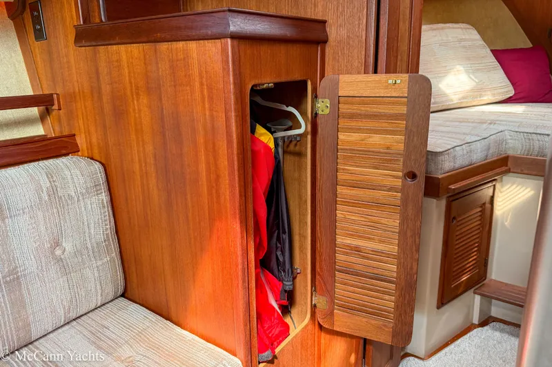 Slide: The Image of Cozy interior of 1989 Island Packet 31 sailboat with wooden cabinetry and seating. - 41