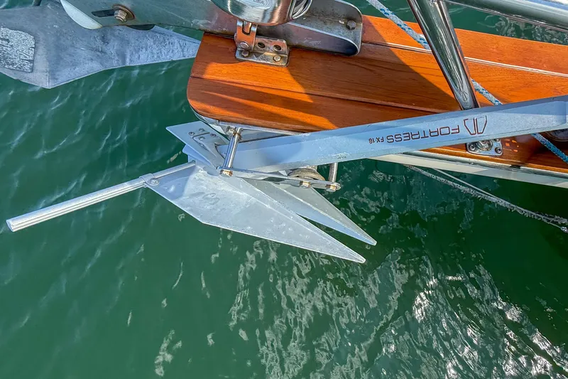 Slide: The Image of Anchor on 1989 Island Packet 31 sailboat, featuring a Fortress FX-16, over water. - 53