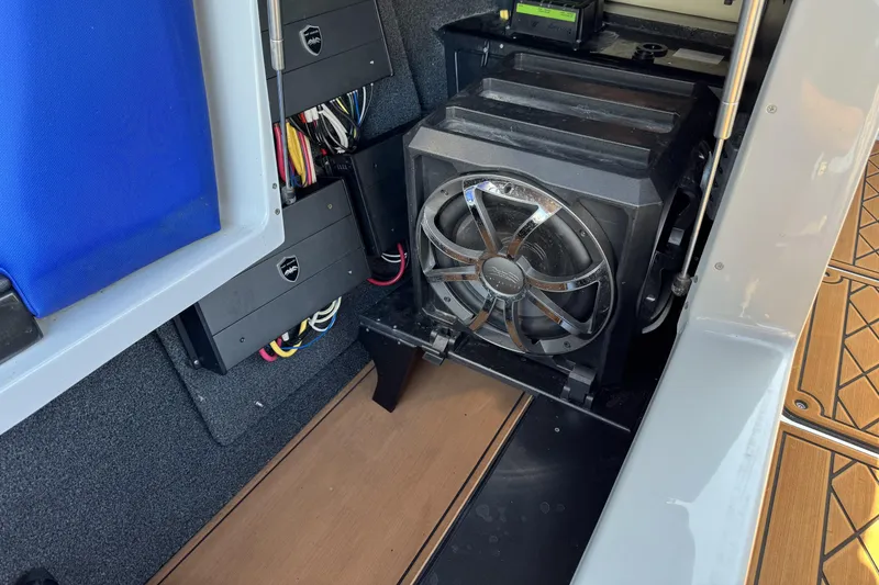 Slide: The Image of 2019 Tigé ZX5 boat interior showing audio system and wiring components. - 14