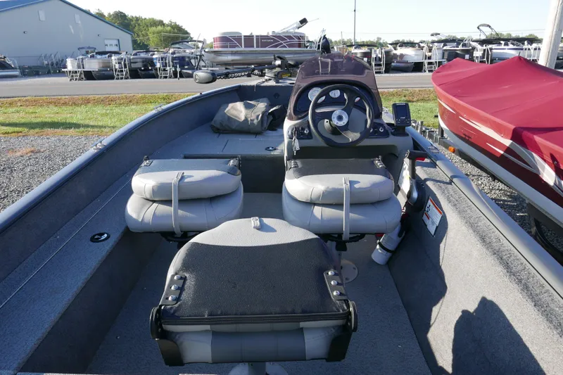 Slide: The Image of 2018 Tracker Super Guide V-16 boat interior with steering console and seating. - 5
