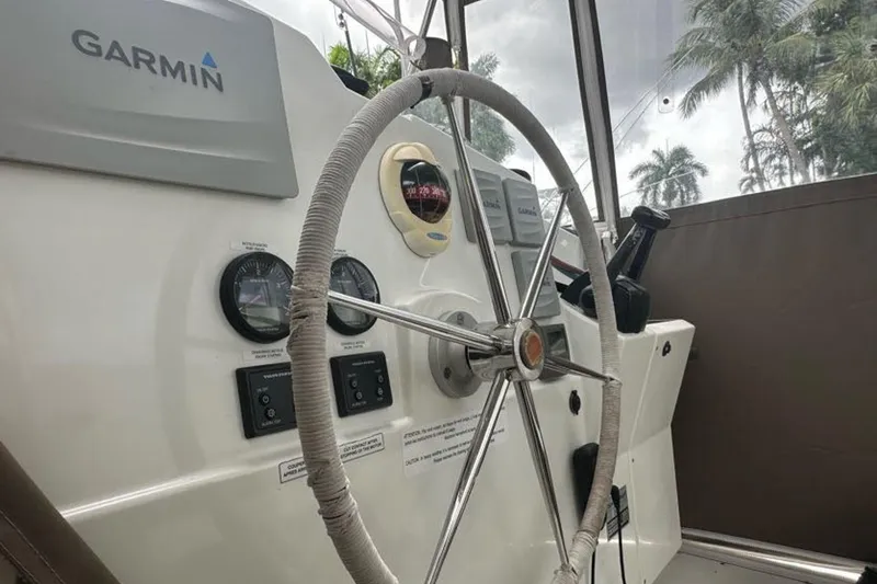 Slide: The Image of Steering wheel and controls of 2017 Fountaine Pajot Lucia 40 catamaran with Garmin navigation. - 24