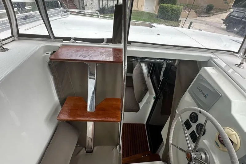 Slide: The Image of 2017 Fountaine Pajot Lucia 40 yacht helm with Garmin navigation system and wooden accents. - 26