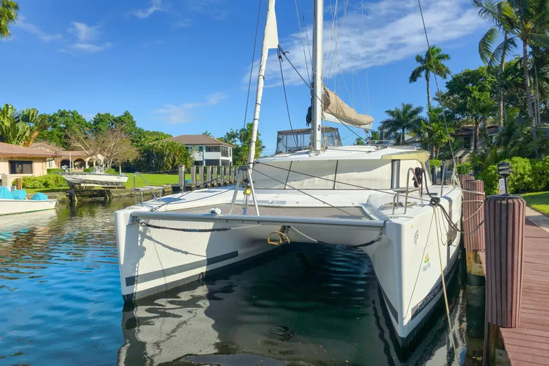 Slide: The Image of 2017 Fountaine Pajot Lucia 40 catamaran docked in a tropical marina setting. - 3