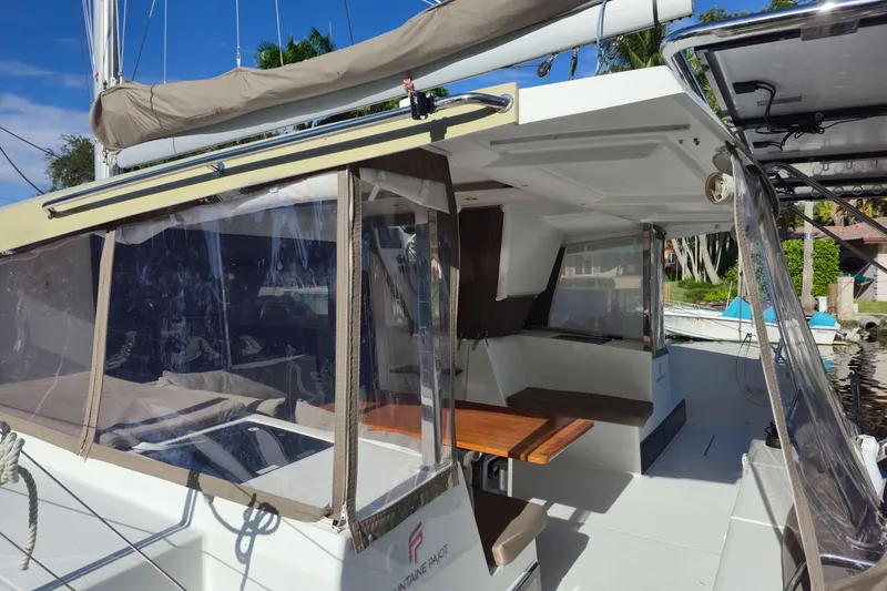 Slide: The Image of 2017 Fountaine Pajot Lucia 40 catamaran with covered cockpit and seating area. - 33