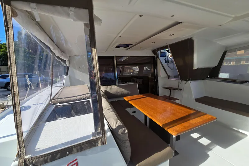 Slide: The Image of 2017 Fountaine Pajot Lucia 40 catamaran interior with seating and wooden table. - 36
