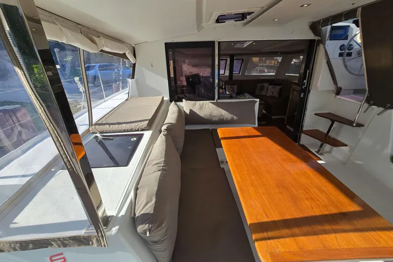 Slide: The Image of Interior of 2017 Fountaine Pajot Lucia 40 catamaran with seating and wooden table. - 37