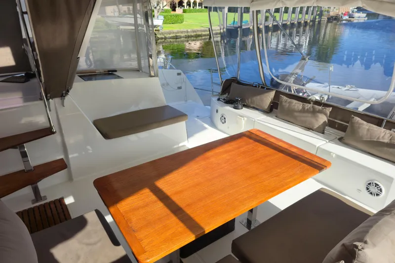 Slide: The Image of Spacious deck of 2017 Fountaine Pajot Lucia 40 catamaran with seating and wooden table. - 38