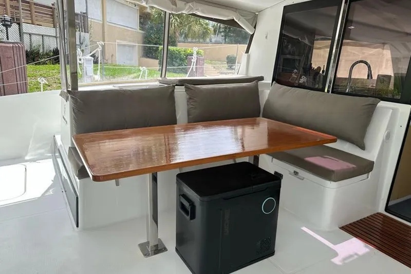 Slide: The Image of 2017 Fountaine Pajot Lucia 40 catamaran interior with dining area and cushioned seating. - 41