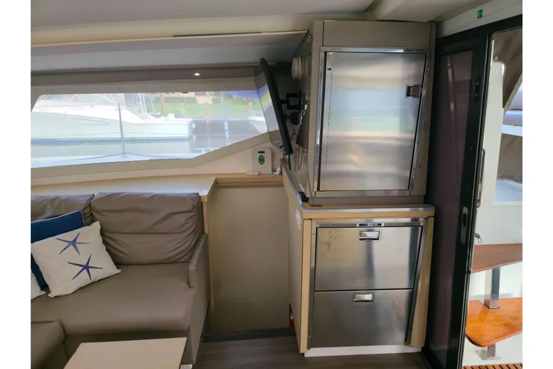 Slide: The Image of Interior of 2017 Fountaine Pajot Lucia 40 catamaran with modern seating and stainless steel appliances. - 48