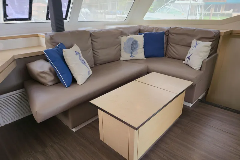 Slide: The Image of Luxurious interior of 2017 Fountaine Pajot Lucia 40 catamaran with cozy seating and nautical-themed cushions. - 52