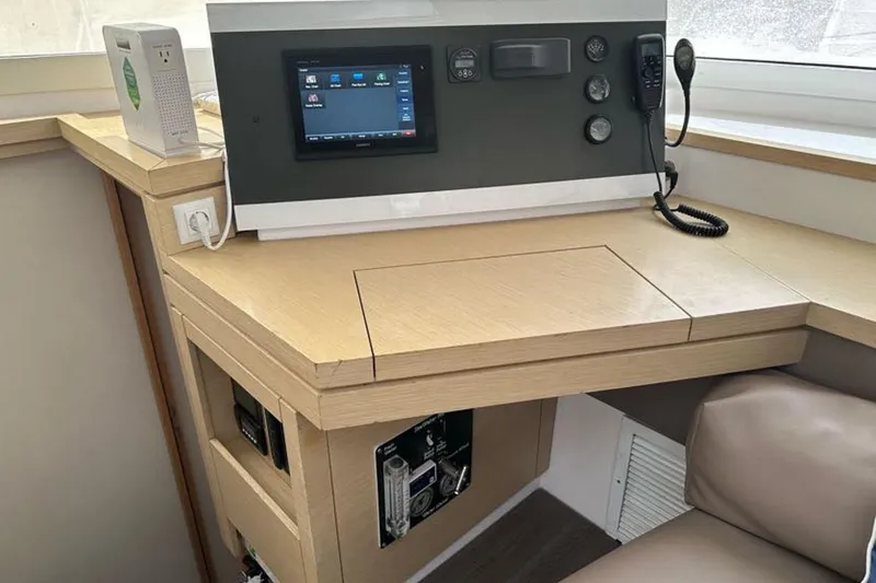 Slide: The Image of Navigation station on 2017 Fountaine Pajot Lucia 40 catamaran with control panel and seating. - 53