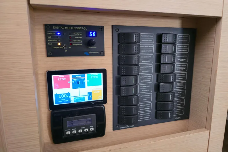 Slide: The Image of Control panel of a 2017 Fountaine Pajot Lucia 40 catamaran, featuring digital displays and switches. - 56
