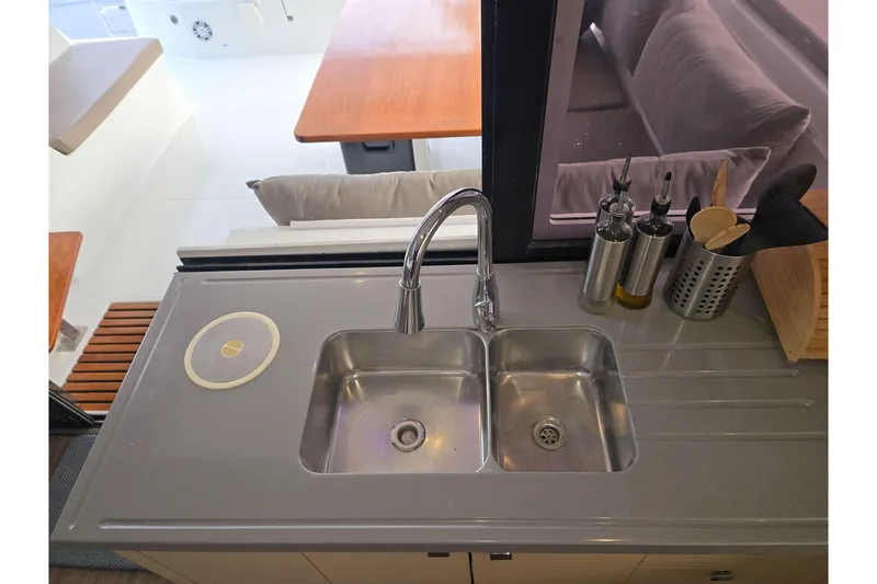 Slide: The Image of Modern kitchen sink on 2017 Fountaine Pajot Lucia 40 catamaran, with utensils and oil bottles. - 58