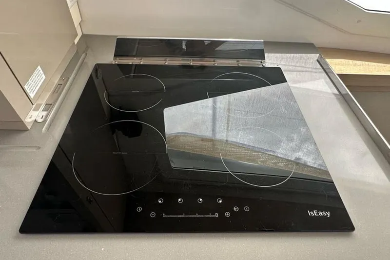 Slide: The Image of Modern black glass cooktop on 2017 Fountaine Pajot Lucia 40 yacht kitchen. - 61