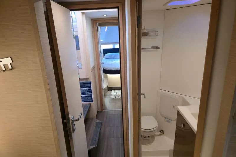 Slide: The Image of Interior of 2017 Fountaine Pajot Lucia 40, featuring a compact bathroom and cozy bedroom. - 67