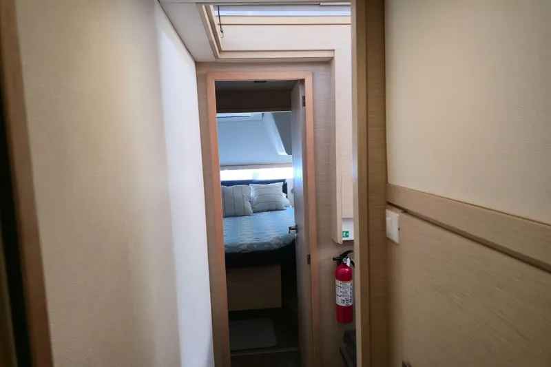 Slide: The Image of Interior view of 2017 Fountaine Pajot Lucia 40 yacht cabin with bed and fire extinguisher. - 80