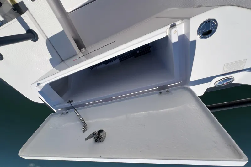 Slide: The Image of Open storage compartment on a 2021 Axopar 28 boat, showing interior details. - 14