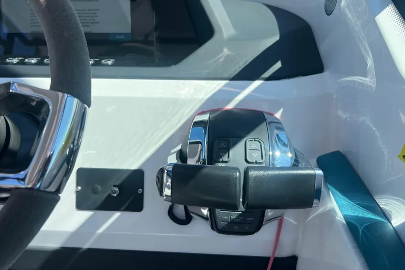 Slide: The Image of Close-up of 2021 Axopar 28 boat throttle controls and steering wheel. - 20
