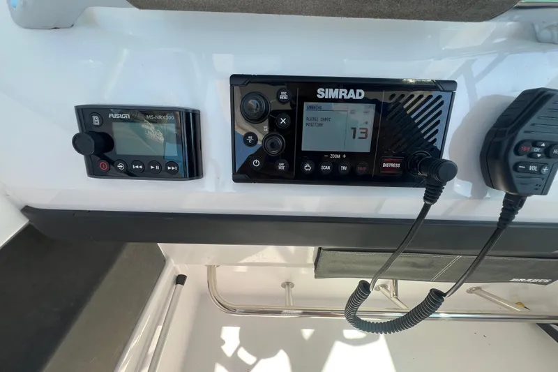 Slide: The Image of Control panel of a 2021 Axopar 28 boat featuring Simrad and Fusion devices. - 22