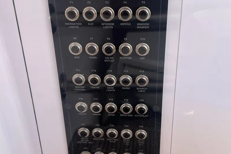 Slide: The Image of Control panel of a 2021 Axopar 28 boat with labeled switches and outlets. - 25