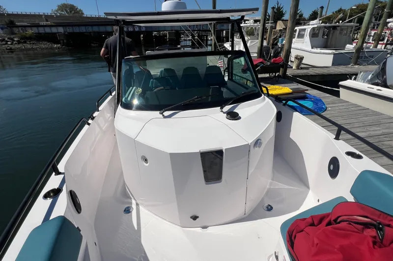 Slide: The Image of 2021 Axopar 28 boat docked, featuring sleek design and spacious deck area. - 28