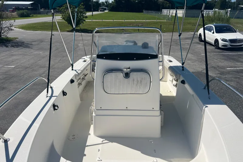 Slide: The Image of 2001 Trophy 1903 Center Console boat with canopy, parked on pavement. - 10