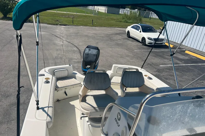 Slide: The Image of 2001 Trophy 1903 Center Console boat with canopy in parking lot. - 11