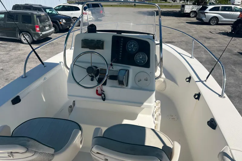 Slide: The Image of 2001 Trophy 1903 Center Console boat interior with steering wheel and gauges. - 13