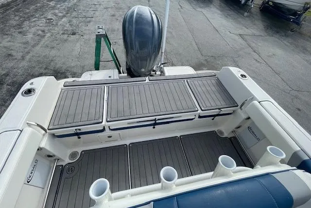Slide: The Image of 2023 Robalo R230 Center Console boat with spacious deck and rod holders. - 13