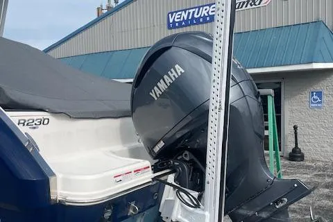 Slide: The Image of 2023 Robalo R230 Center Console with Yamaha outboard motor at dealership. - 16