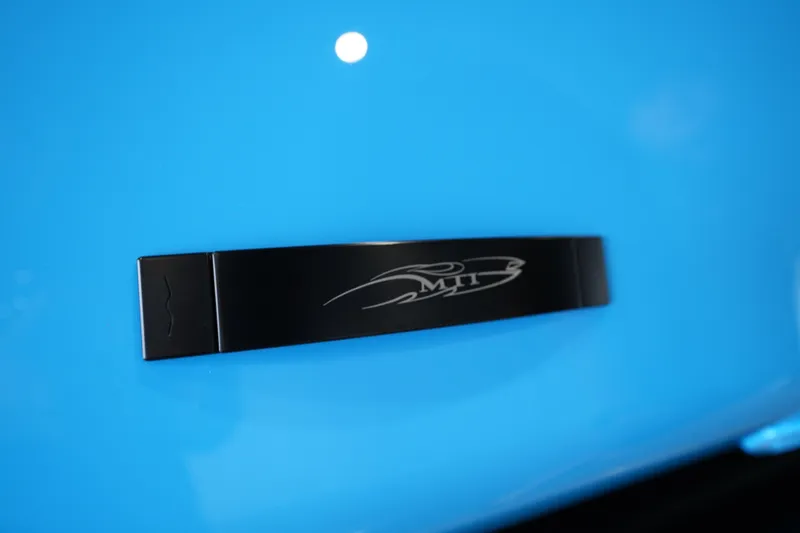 Slide: The Image of Close-up of MTI 440X 2025 logo on sleek blue surface. - 15