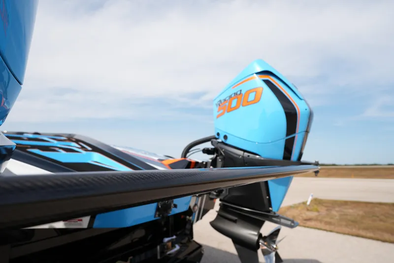 Slide: The Image of 2025 MTI 440X boat with vibrant blue Mercury 500 engine, sleek design. - 21