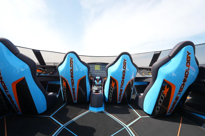 Slide: The Image of Futuristic MTI 440X 2025 boat interior with blue racing seats and advanced dashboard. - 24