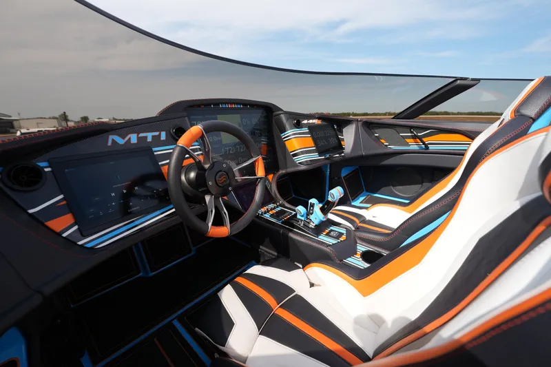Slide: The Image of Futuristic MTI 440X 2025 cockpit with vibrant orange, blue, and white interior design. - 30