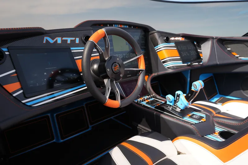Slide: The Image of Interior of 2025 MTI 440X boat with modern dashboard and vibrant accents. - 32